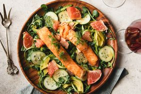 Flat lay of slices of Salmon over watercress salad