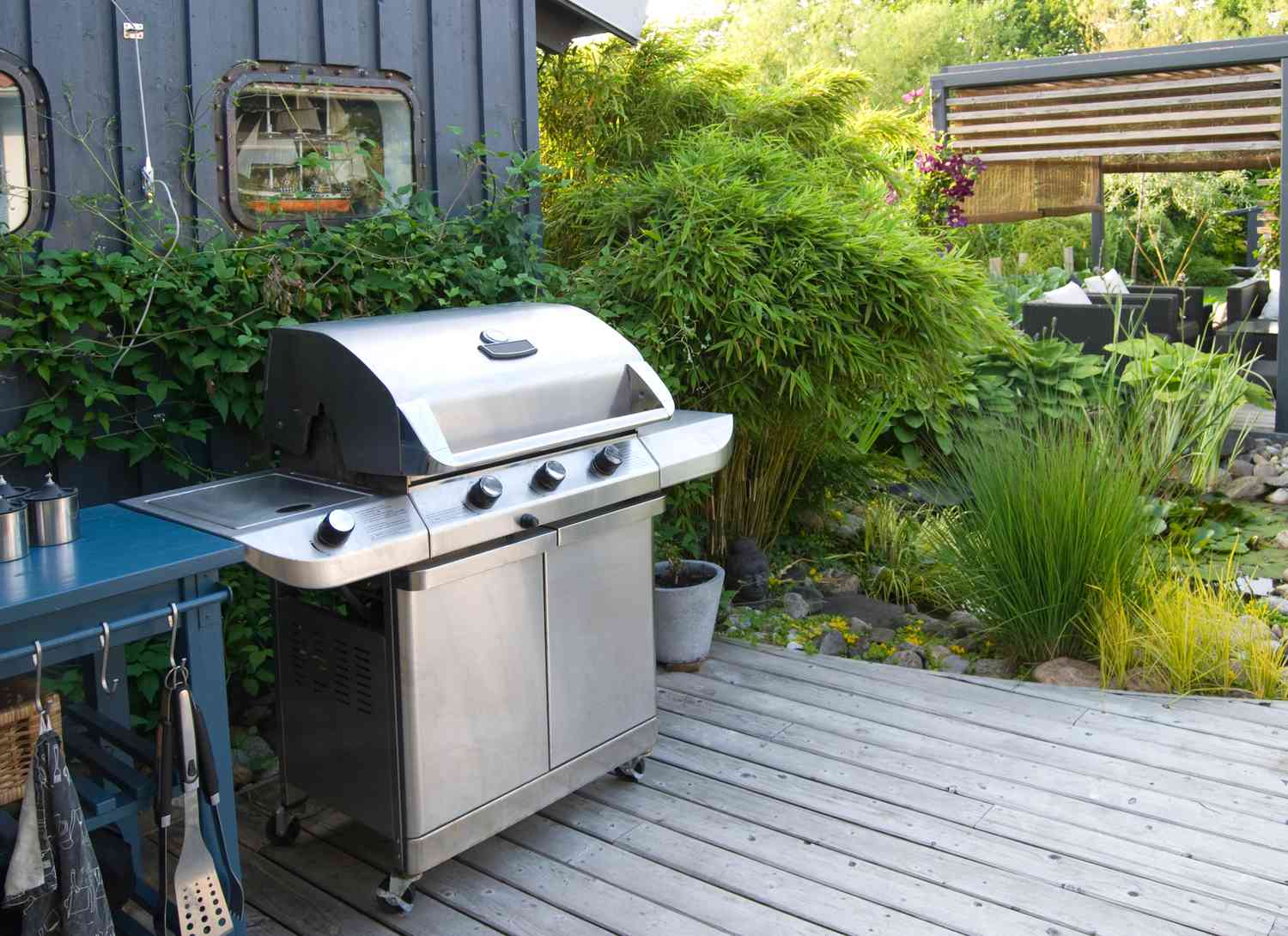 stainless grill on deck in a backyard