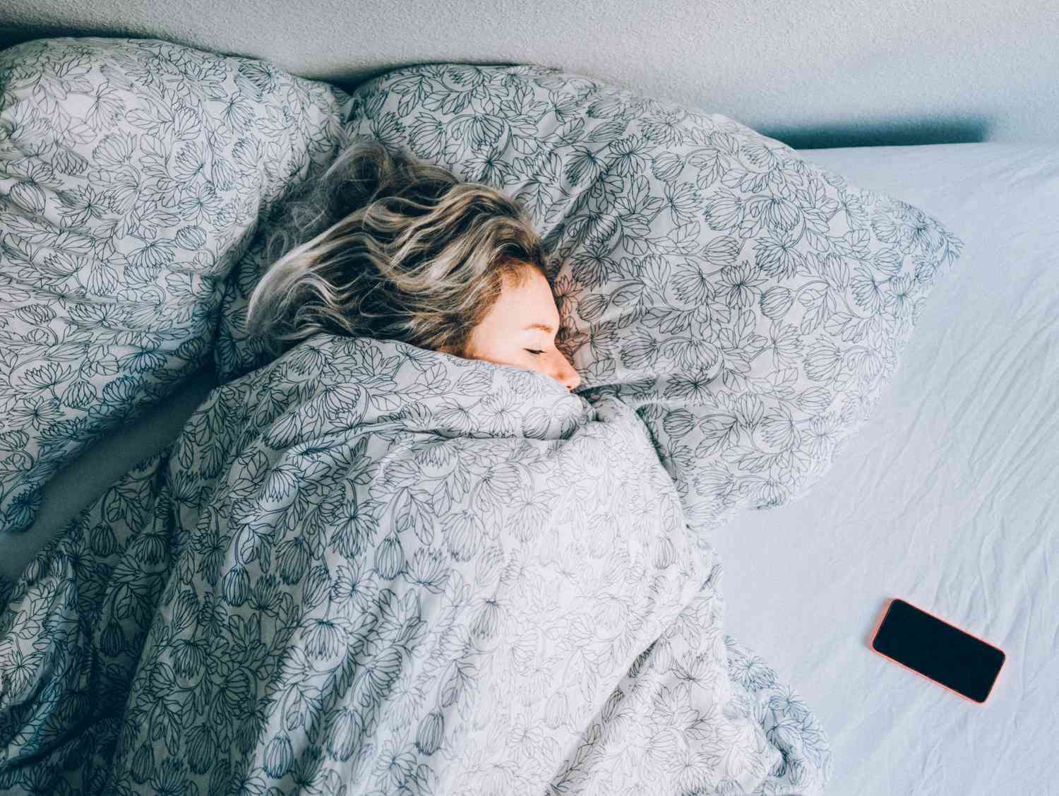 woman sleeping with phone