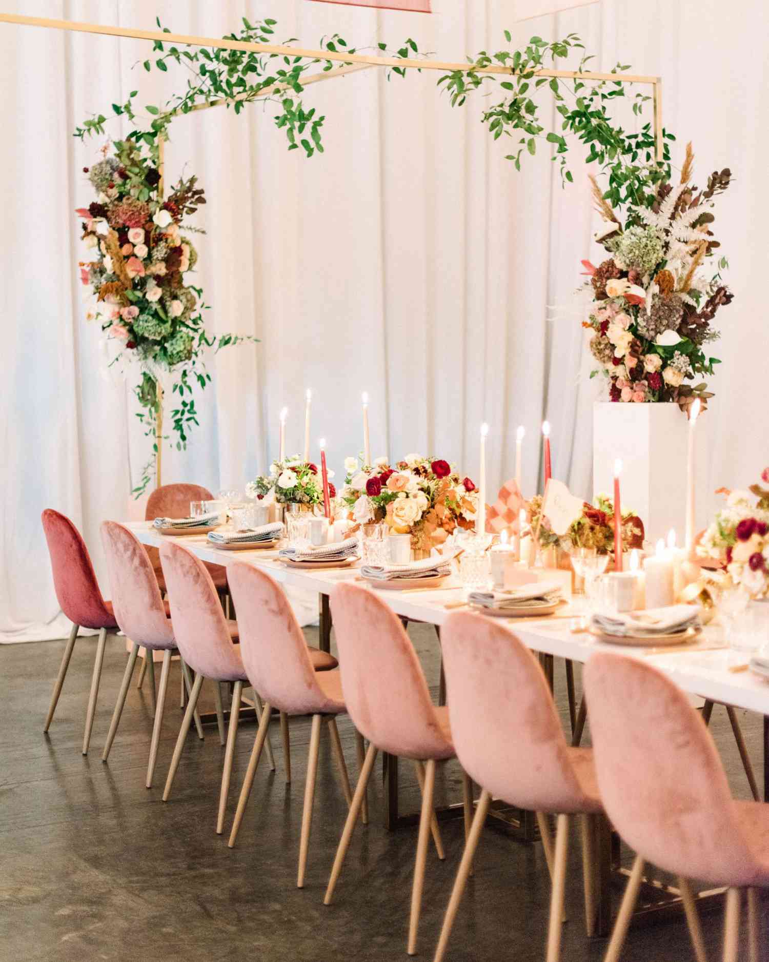 floral arch pink chairs long white table reception decor