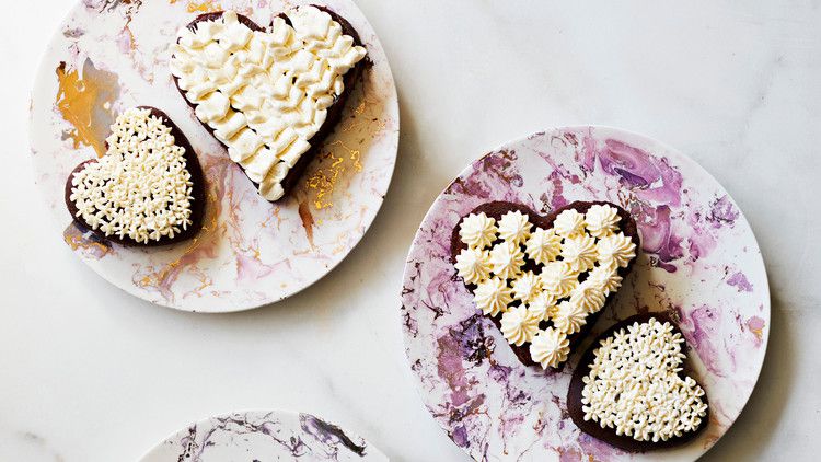 flourless chocolate heart mini cakes topped with swiss-meringue buttercream