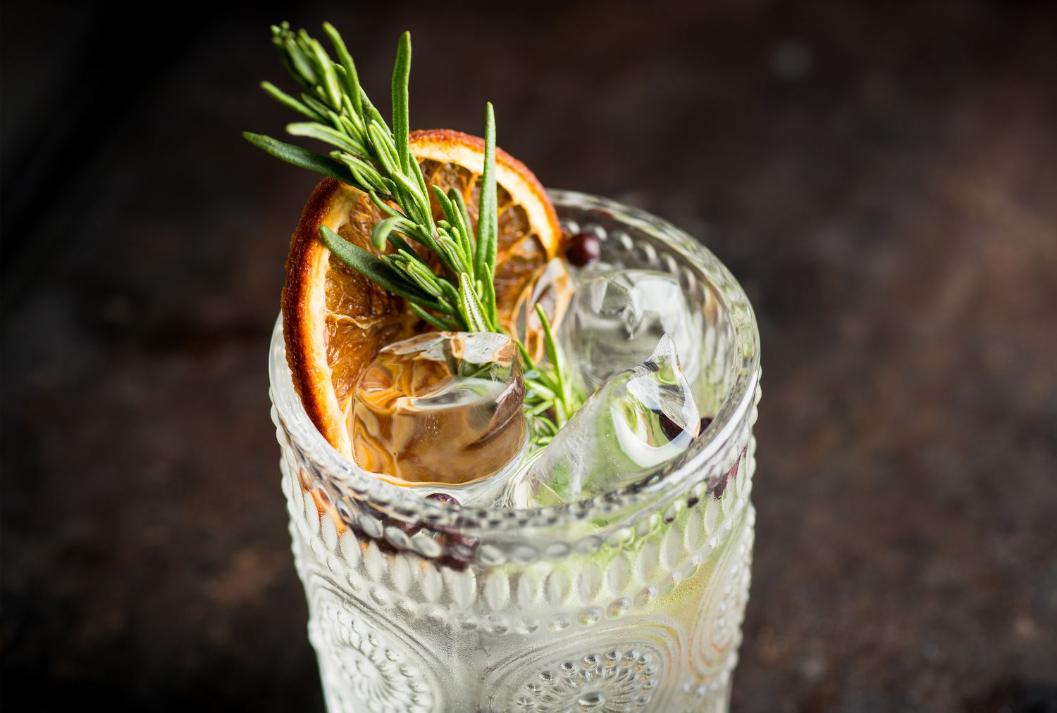 festive cocktail with rosemary and dried orange