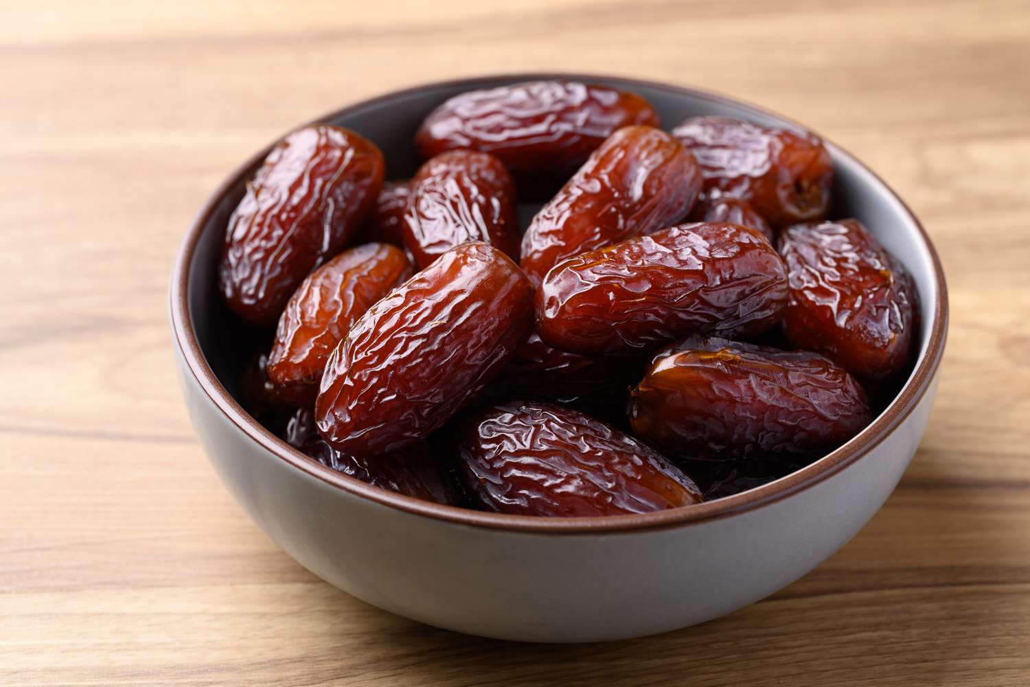 medjool dates in white ceramic bowl