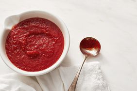 uncooked pizza sauce red white bowl metal spoon