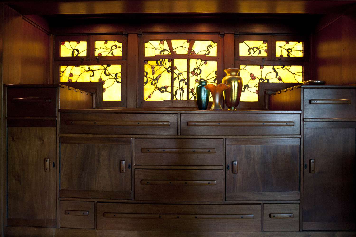 A wood-paneled interior of a home with stained glass