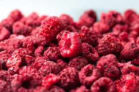Heap of freeze dried raspberries close-up.