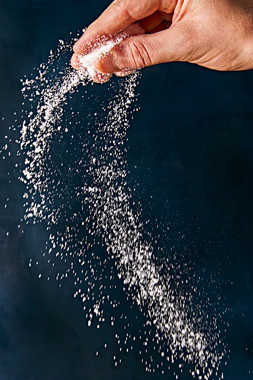 person tossing salt