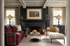 A living room with a fireplace sofa lounge chair and center table