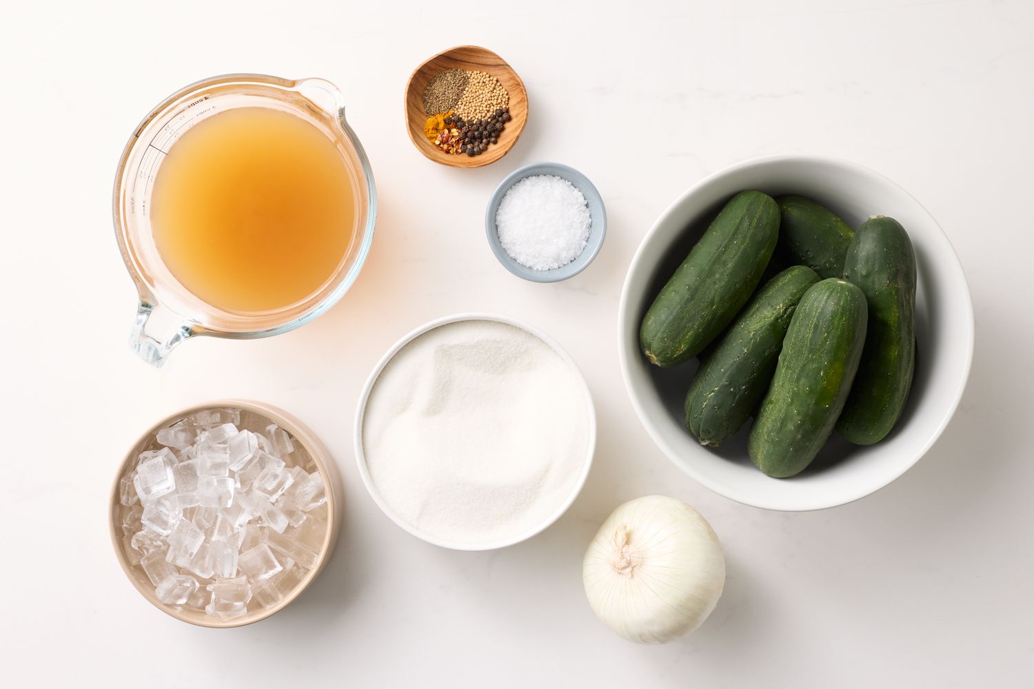 Ingredients for bread and butter pickles cucumbers onion sugar vinegar spices and ice