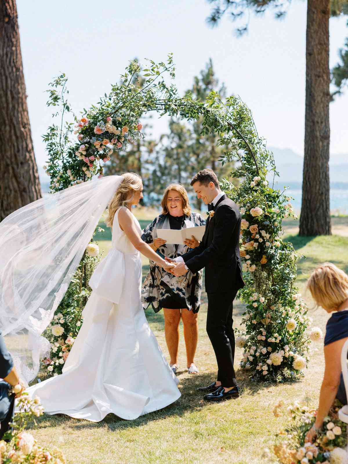 bride and groom holding hands during wedding ceremony vows