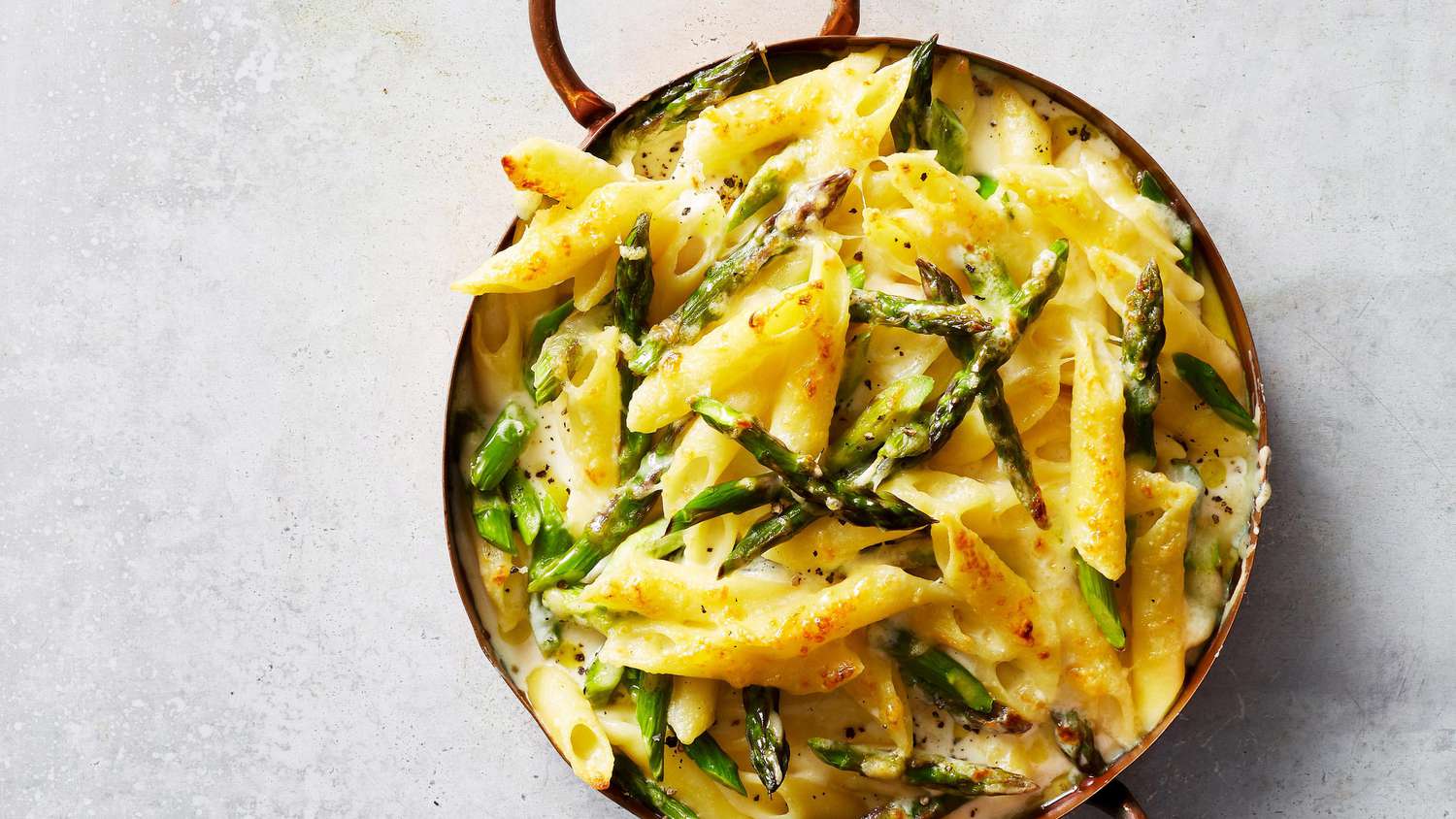 cheesy asparagus pasta in red pot