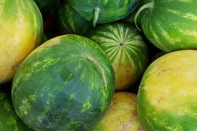 stack of watermelons showing their yellow field spot