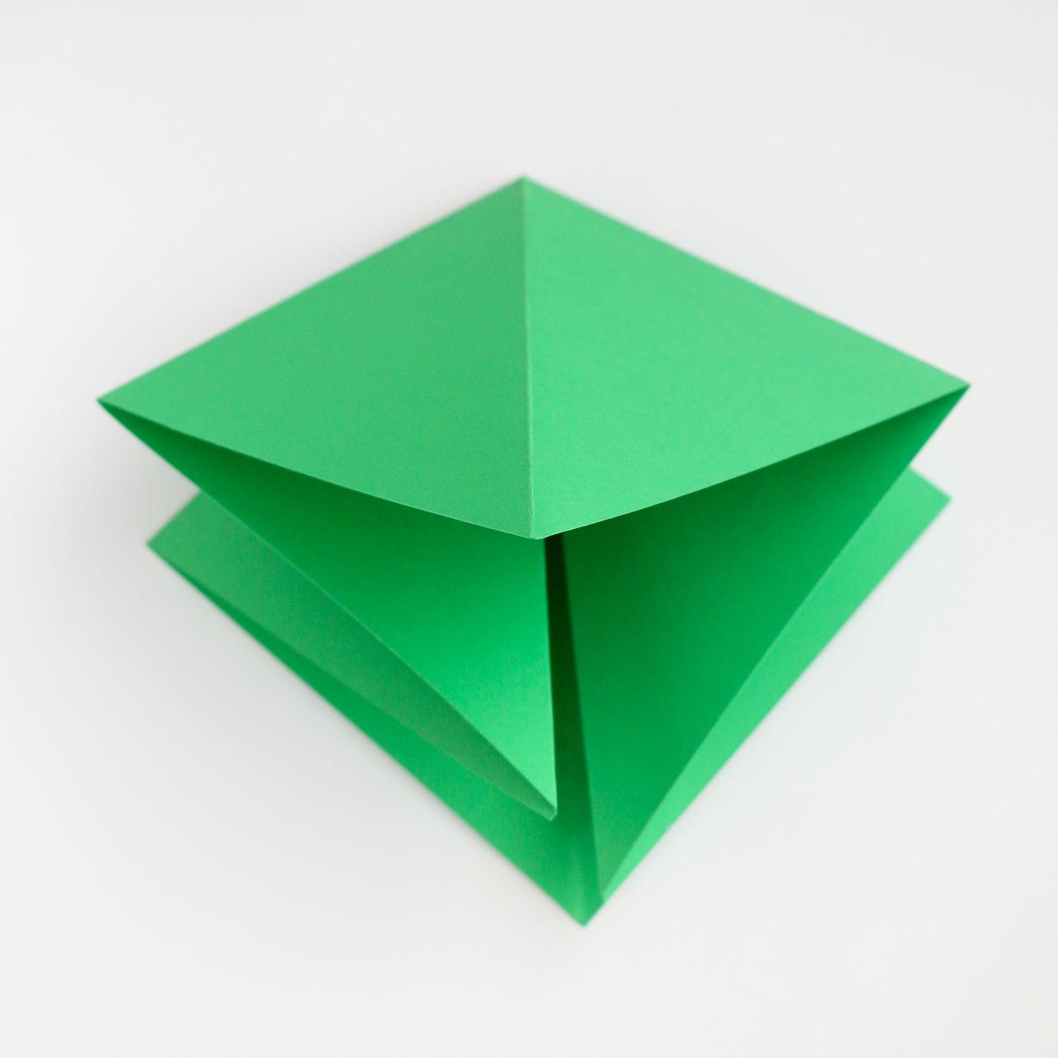Piece of green paper folded into a diamond