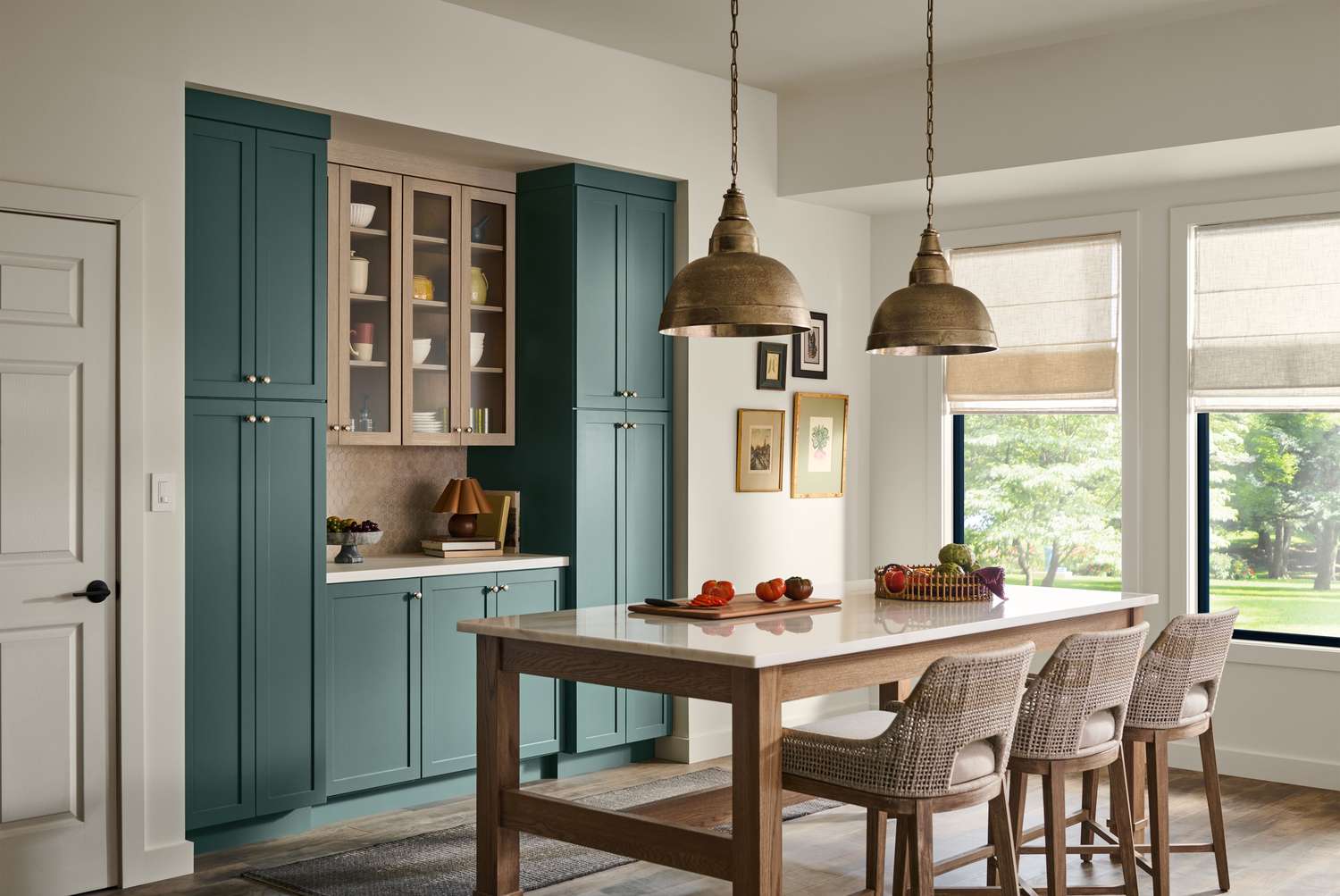 A modern kitchen with a wooden table chairs and teal cabinets