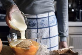 pouring condensed milk into mixing bowl