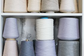 assorted spools of thread on white shelves
