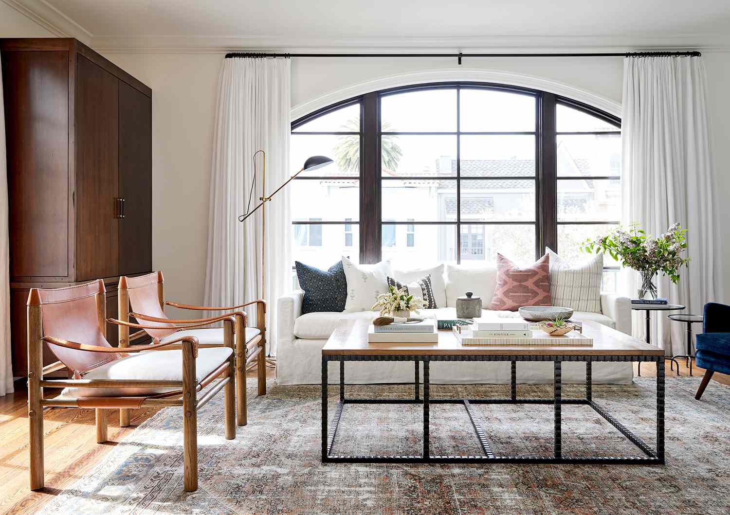 Living room with metal coffee table, couch, and chairs