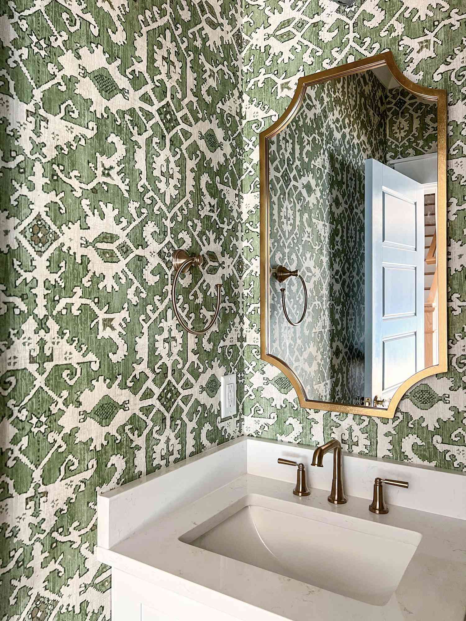 powder room with green printed wallpaper