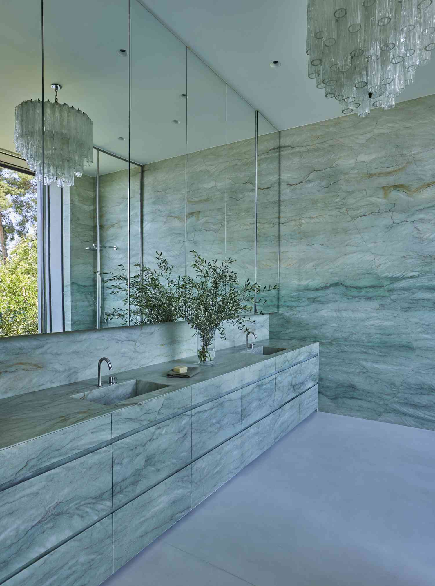 blue bathroom with wall of mirrors