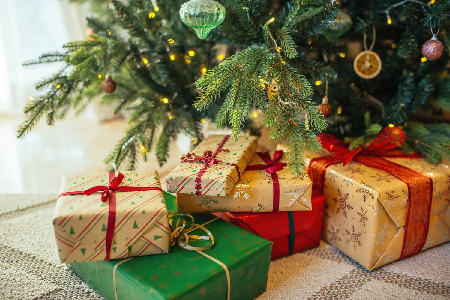 Wrapped gifts under a decorated Christmas tree