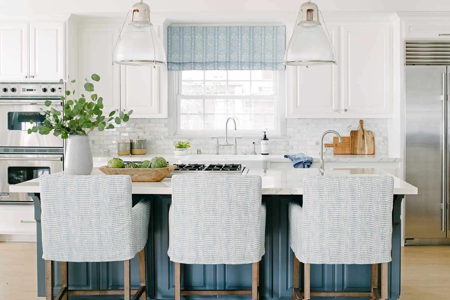 Southern California house white and blue kitchen with big hanging lamps