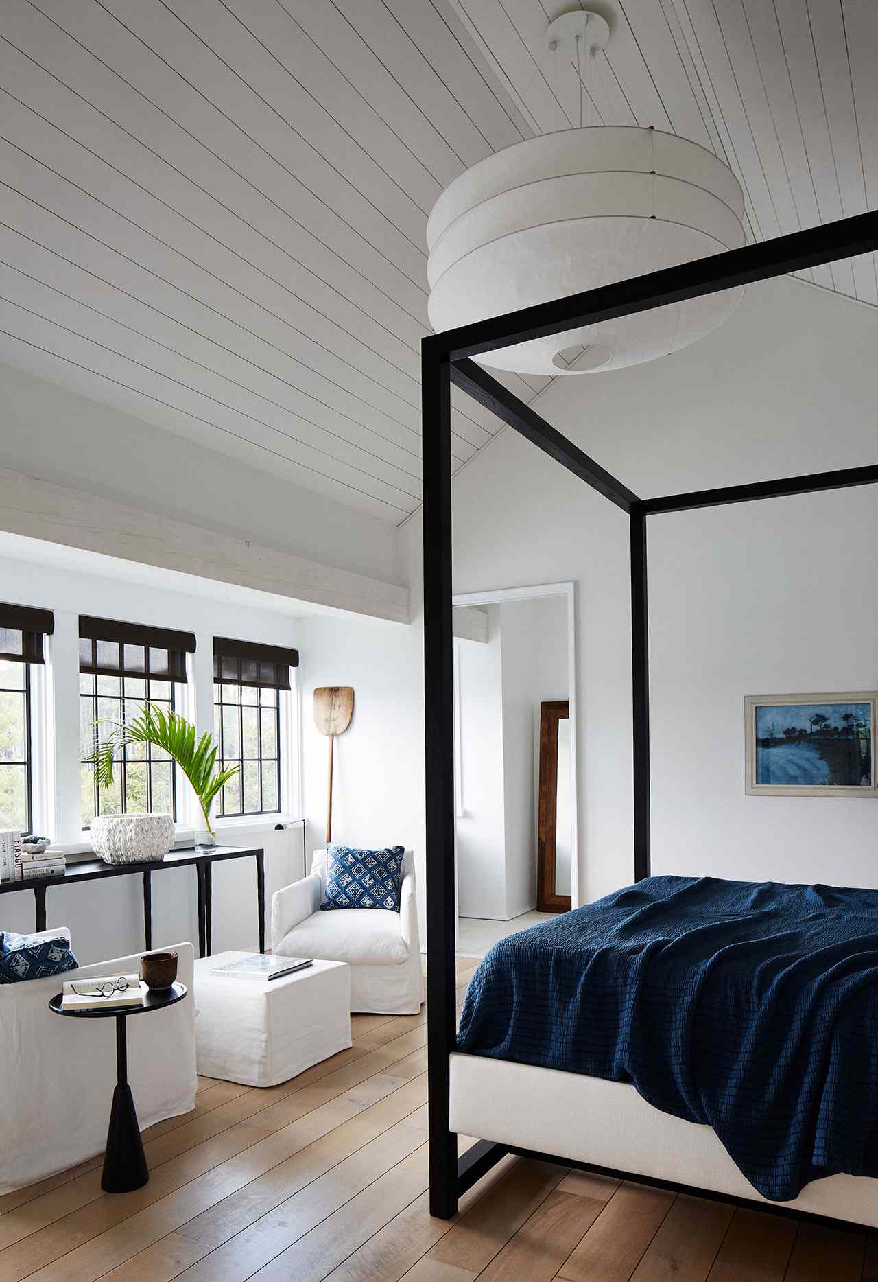 airy master bedroom club chair four-poster bed