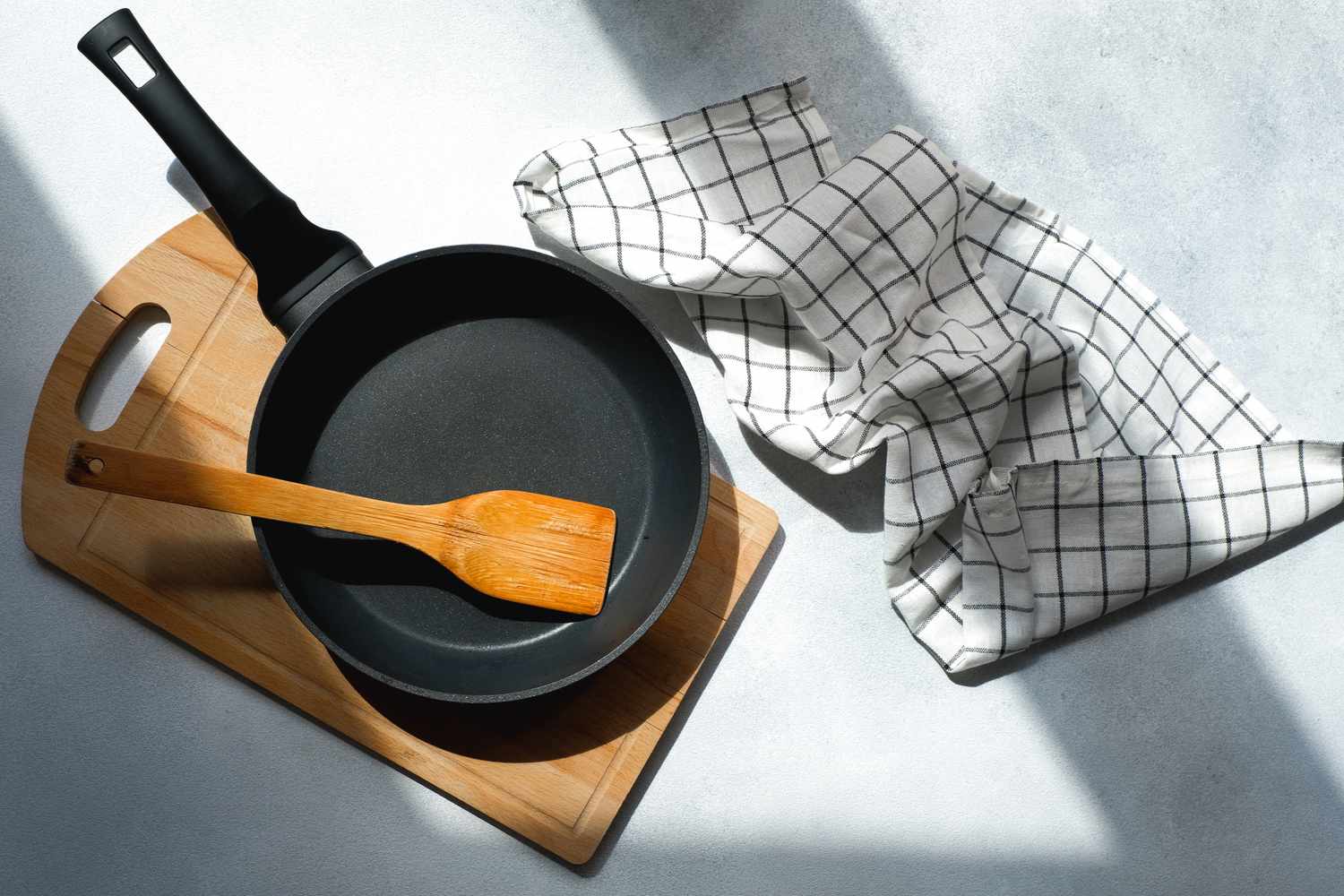 Clean cast iron skillet next to kitchen towel