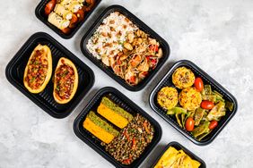 Plastic takeout boxes filled with food