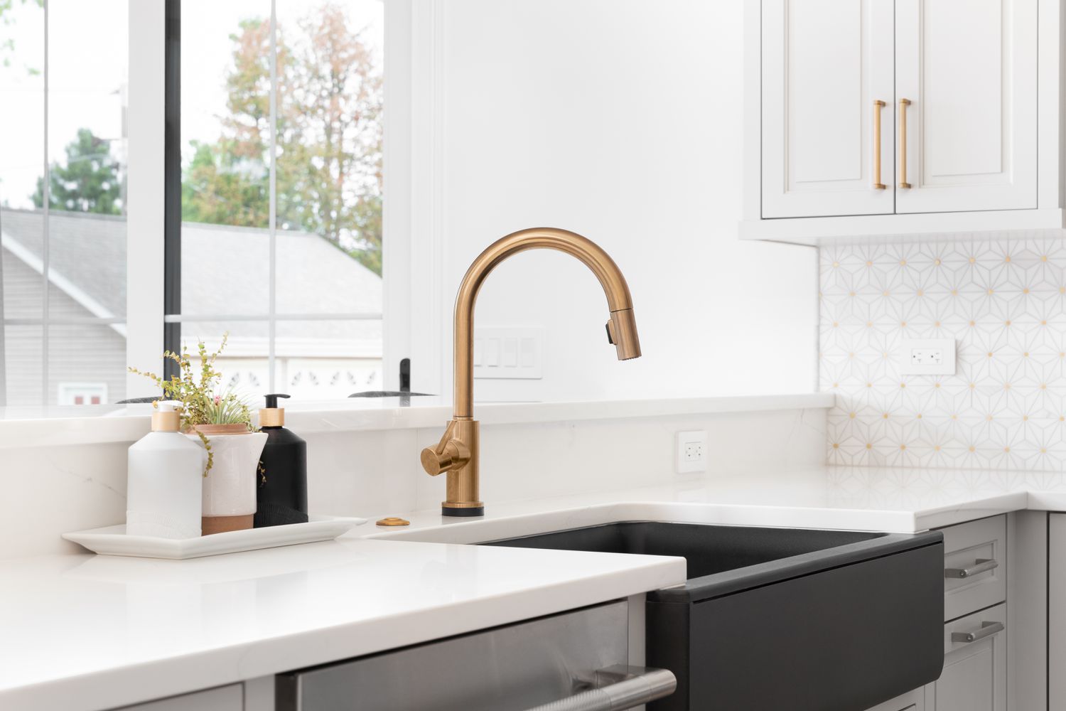 golden faucet and black sink in home kitchen