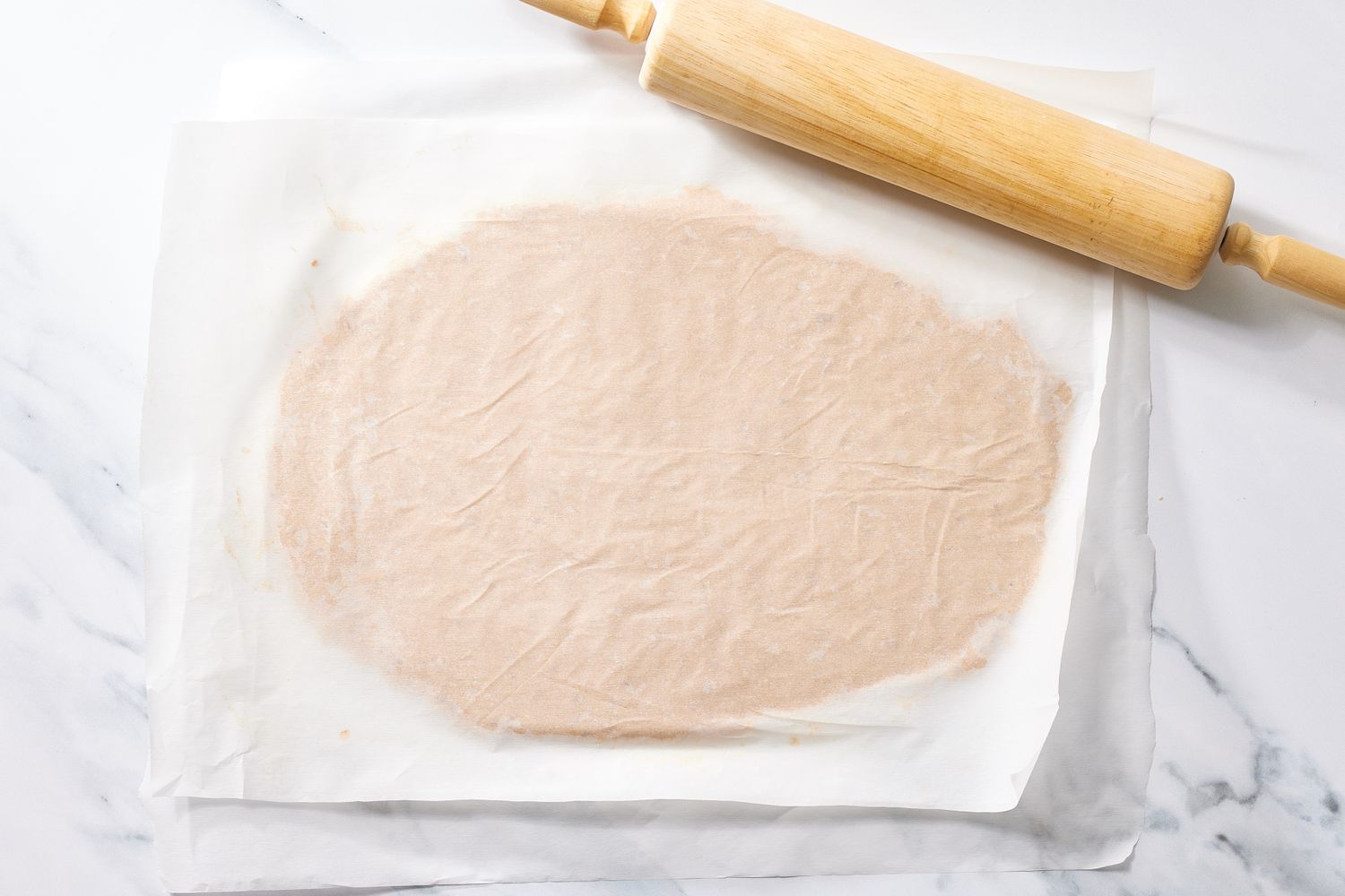 Rolled dough for peanut butter sandwich cookies with rolling pin