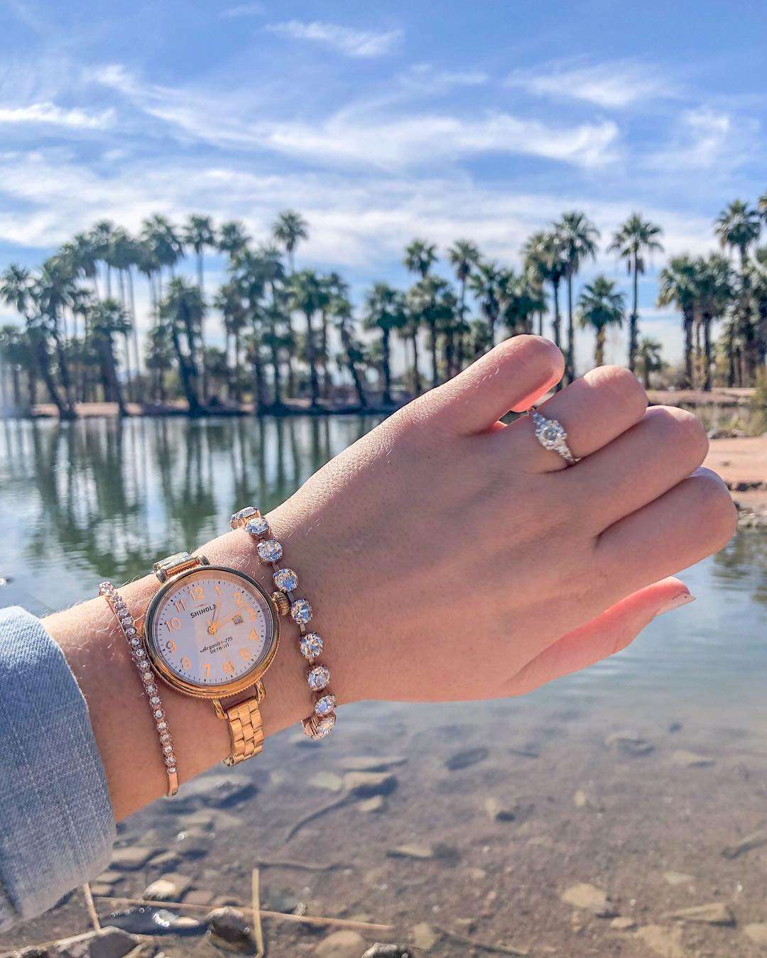 engagement ring selfie palm trees and a body of water