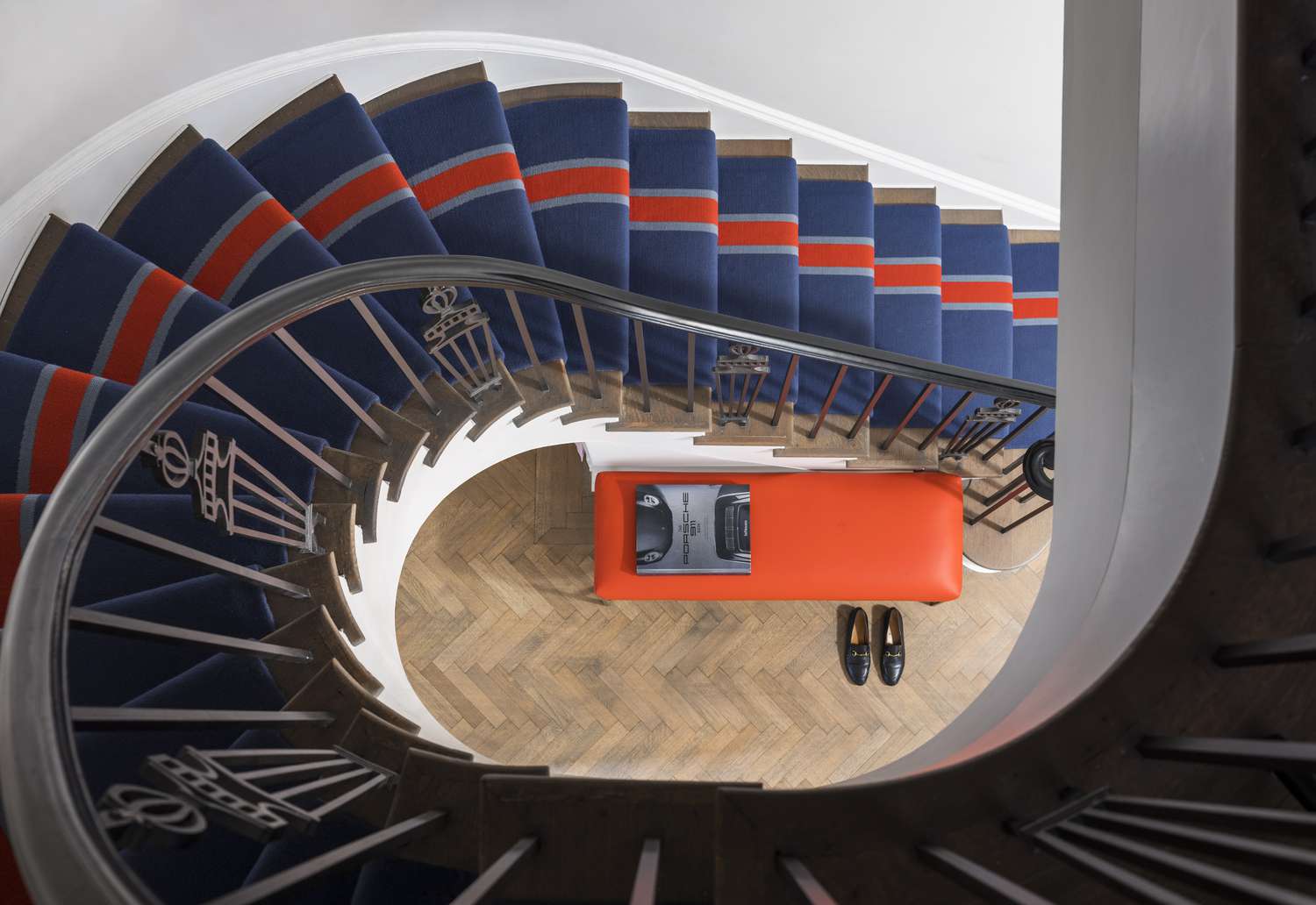 staircase with blue and orange runner