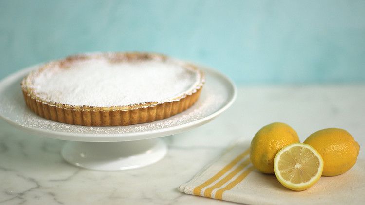 lemon curd souffle tart topped with powdered sugar