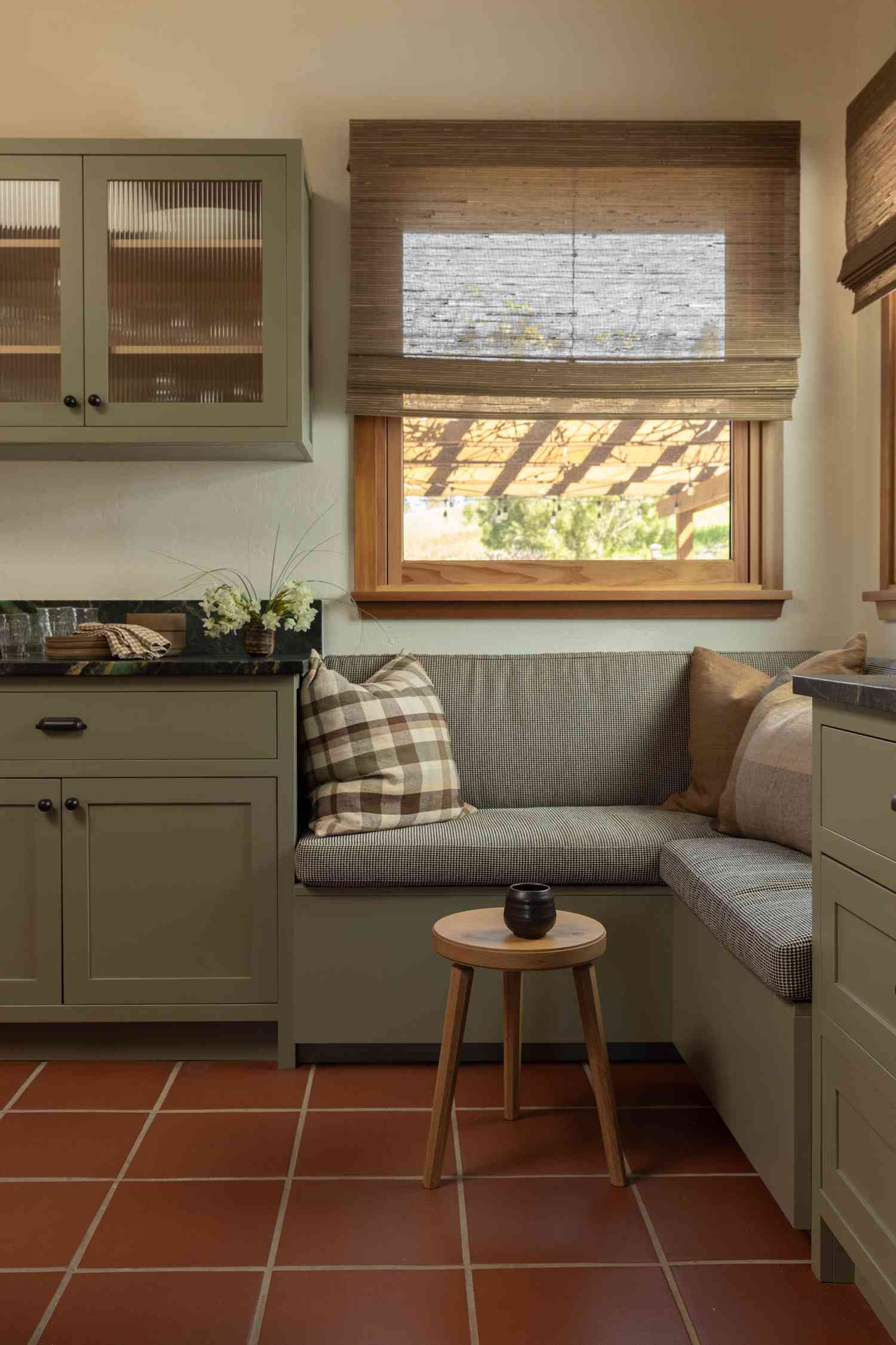 Kitchen design by Decorotation Interiors | Photography by Lauren Andersen, SEN Creative: sage green cabinetry in Farrow & Ball’s Treron, original terracotta floor tiles, custom built-ins, and warm wood accents create a cozy, heritage-inspired space.