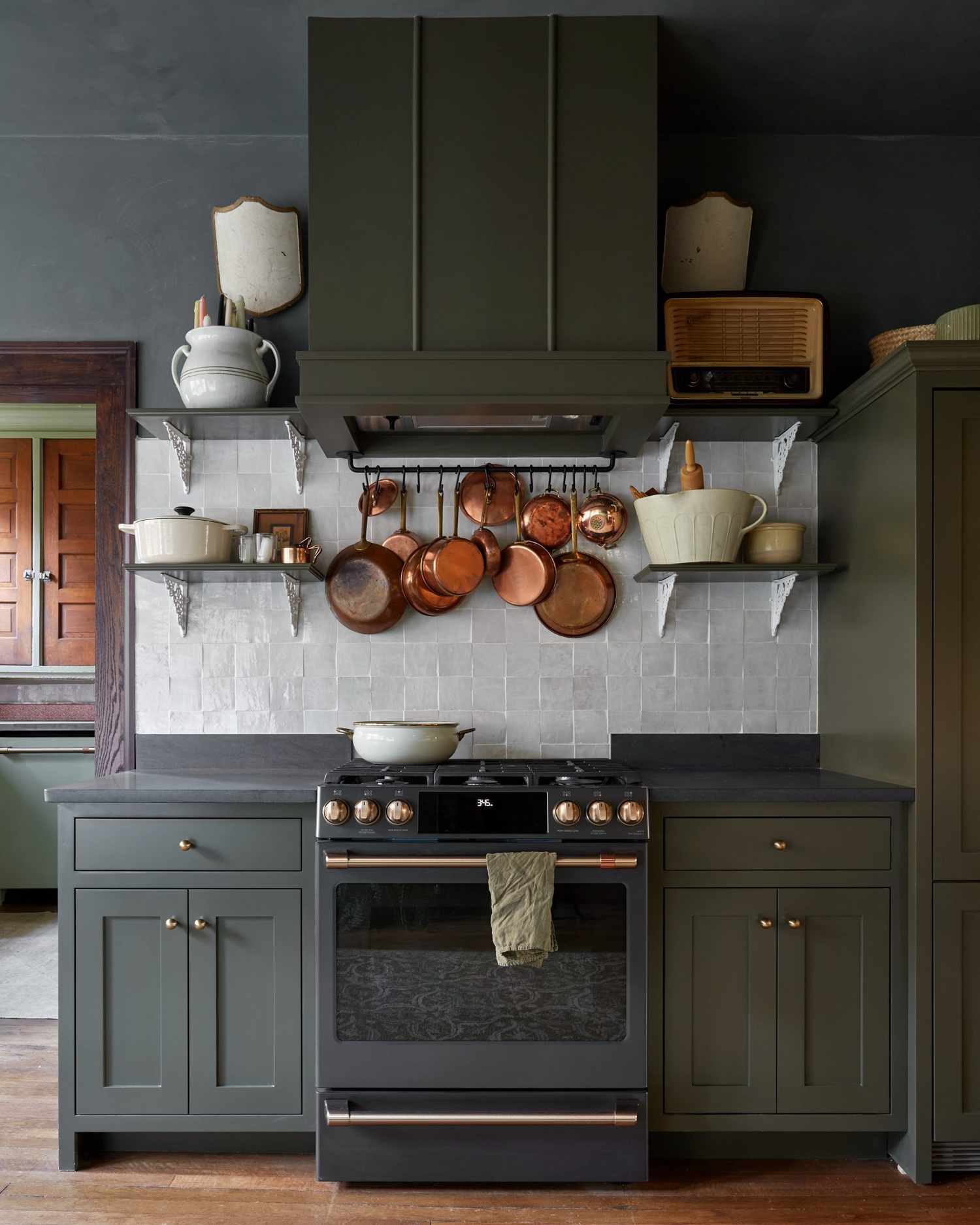 small kitchen with dark green colors