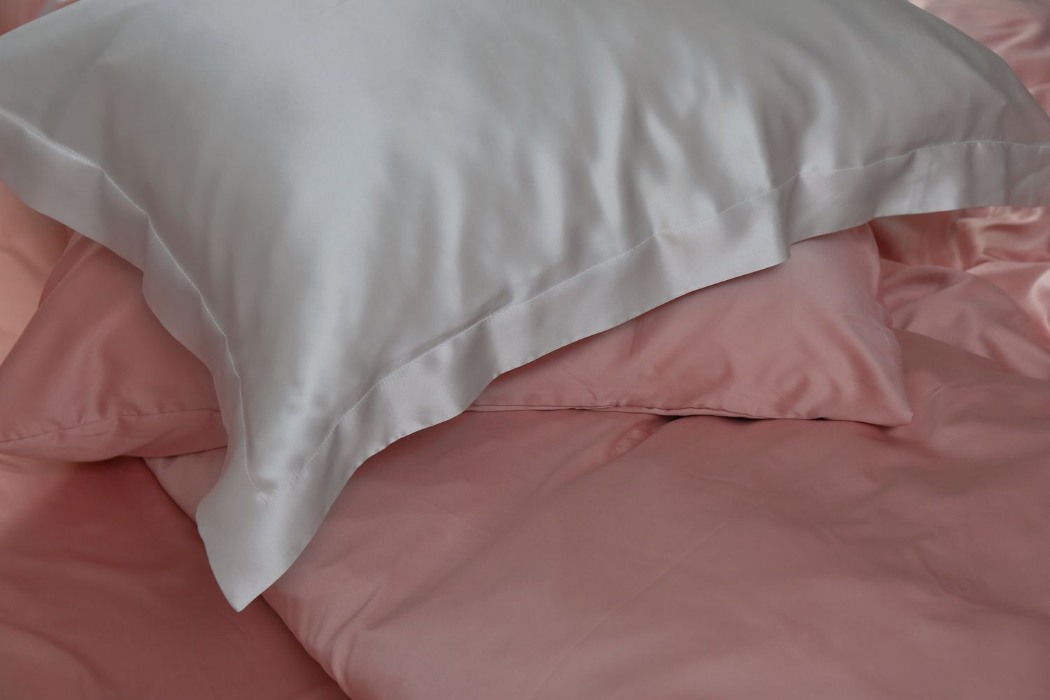 Silk pillowcases on pile on pillows