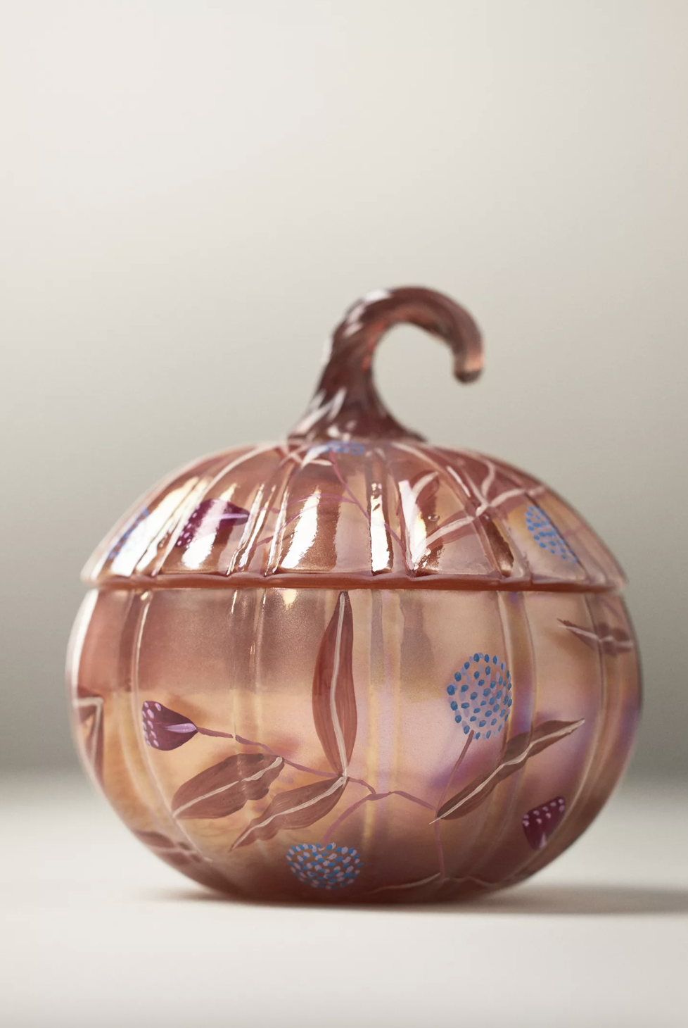 Decorative glass candle in a pumpkinshaped container