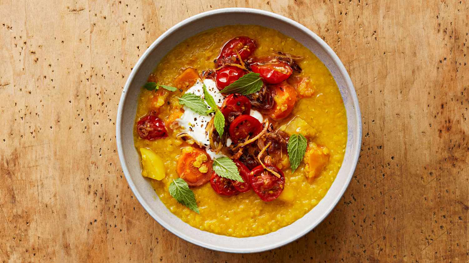golden dal with gingered tomatoes in white bowl