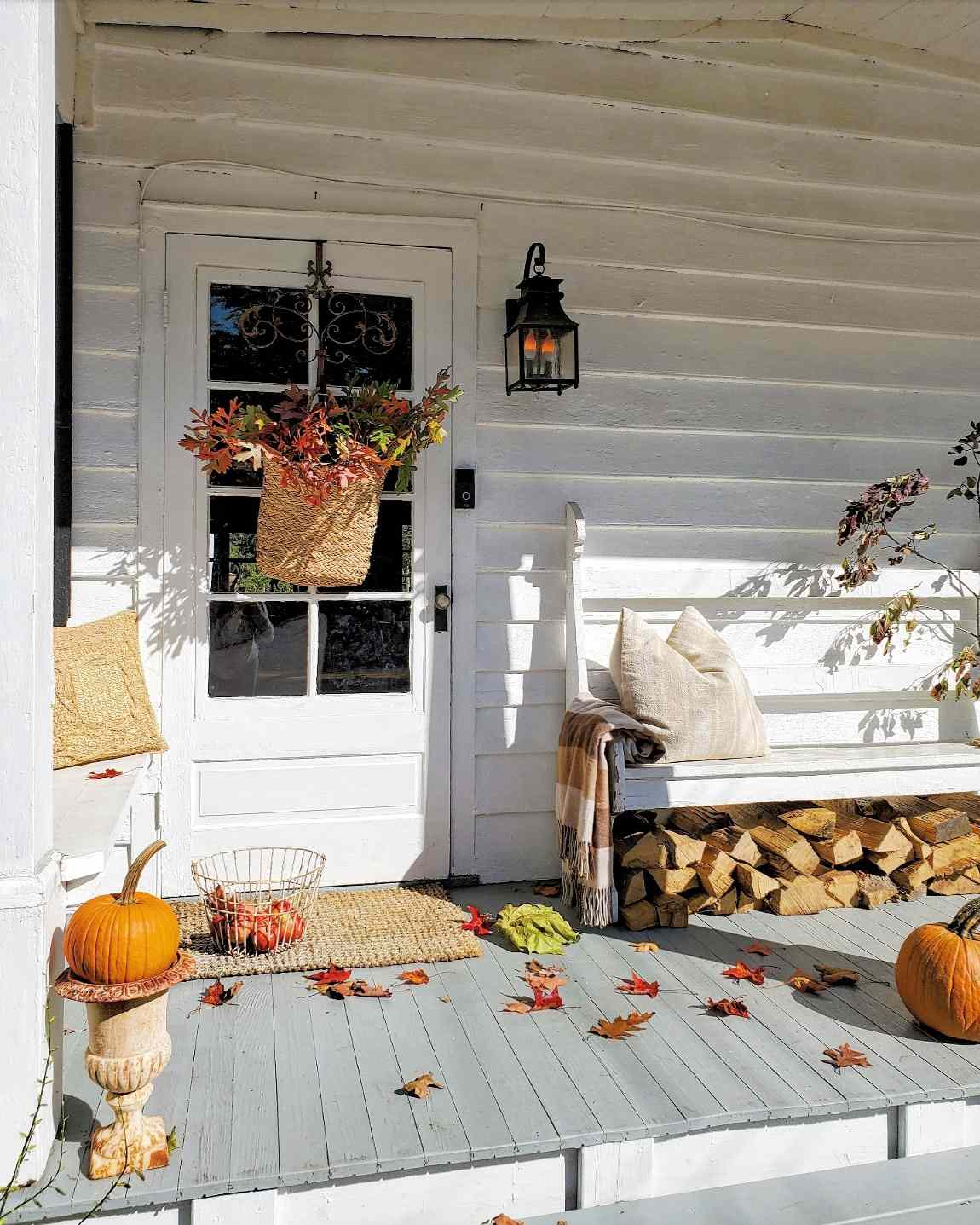 fall porch with colorful leaves in baskets