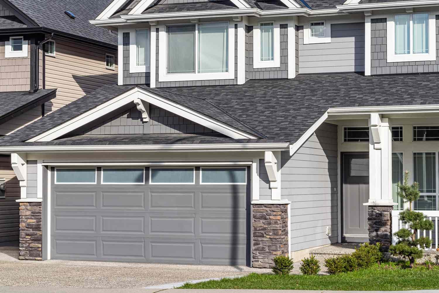 Front view of a modern house with a double garage and a covered entryway