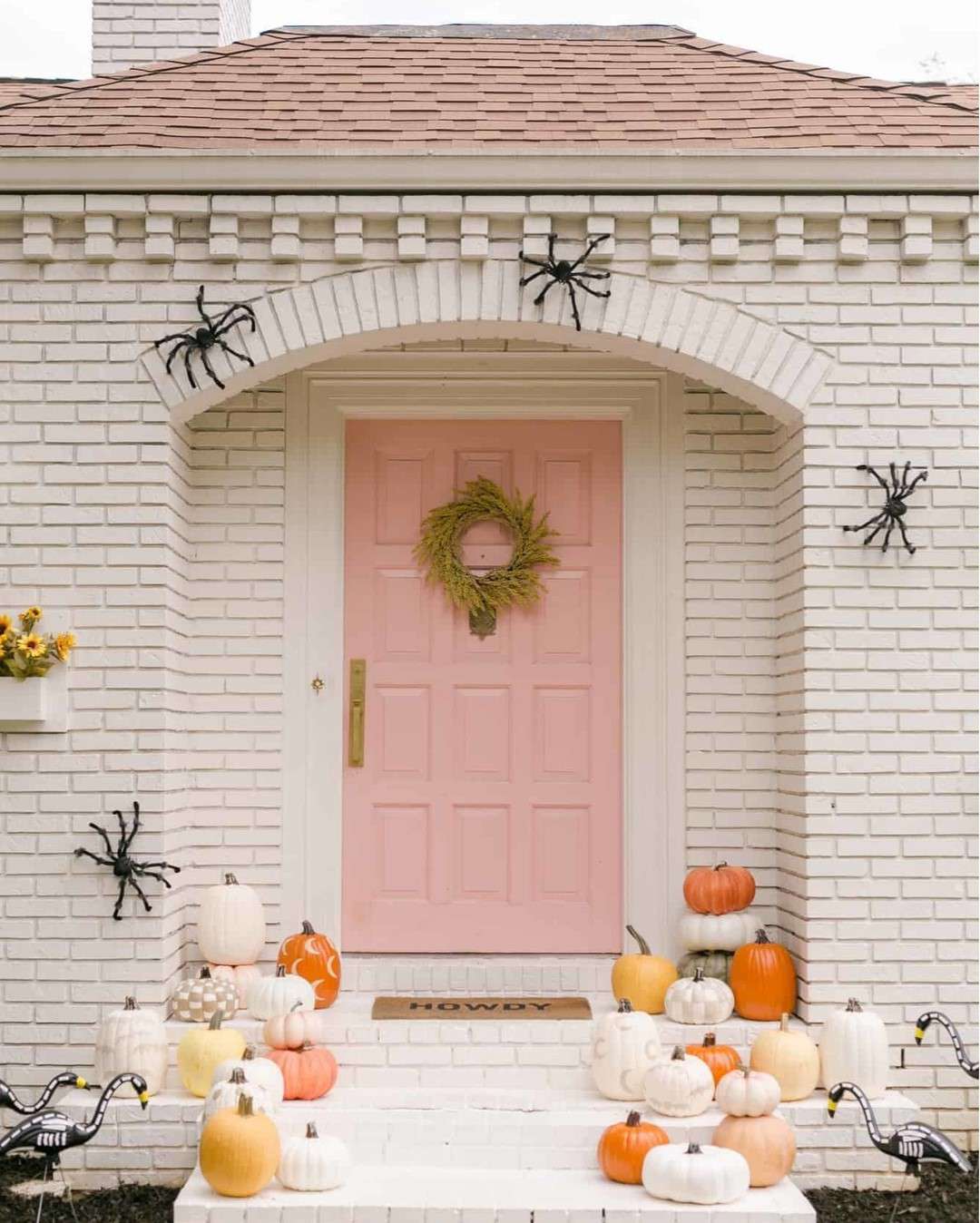 fall porch pink door with wreath assortment of pumpkins