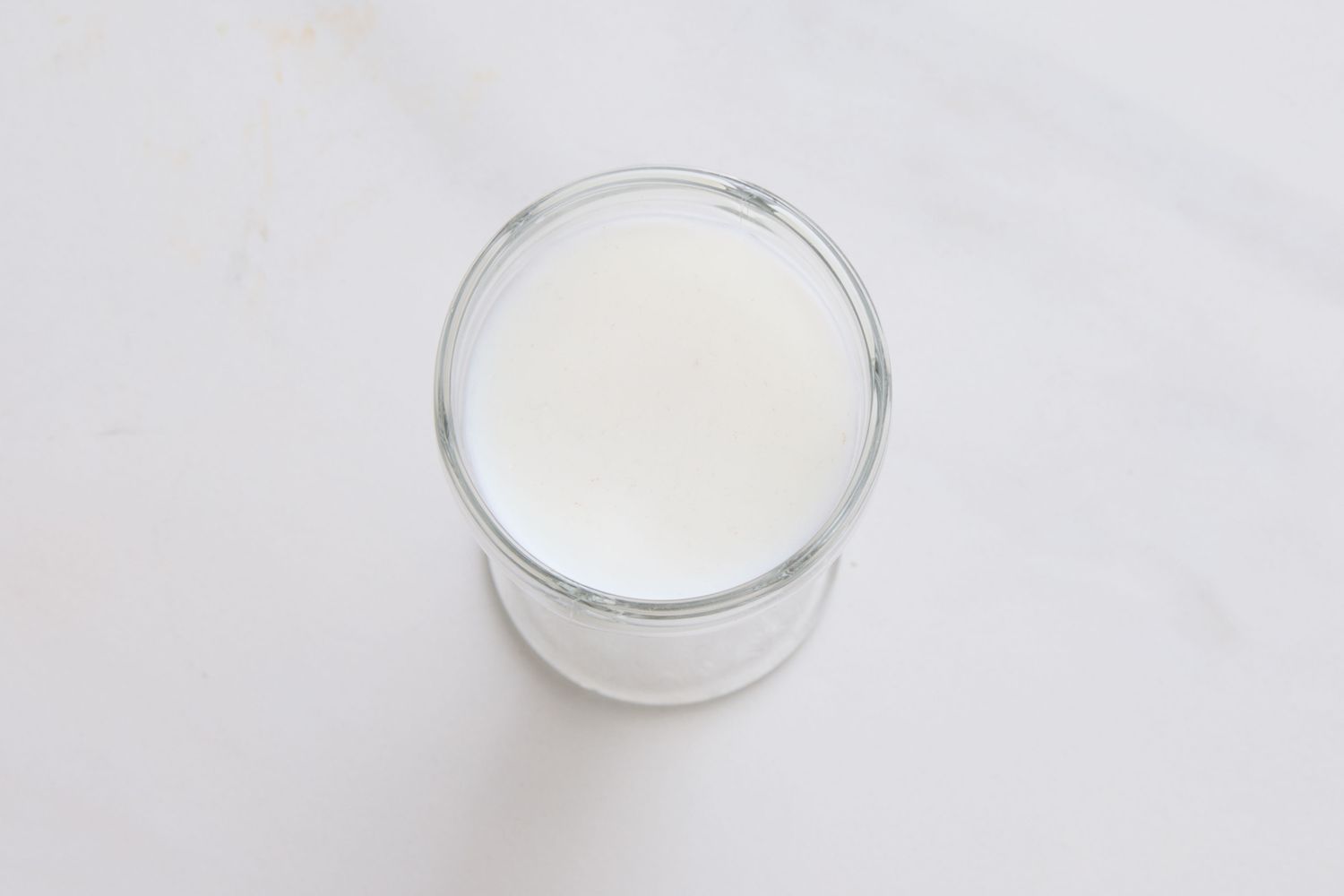 A glass of vanilla egg cream viewed from above