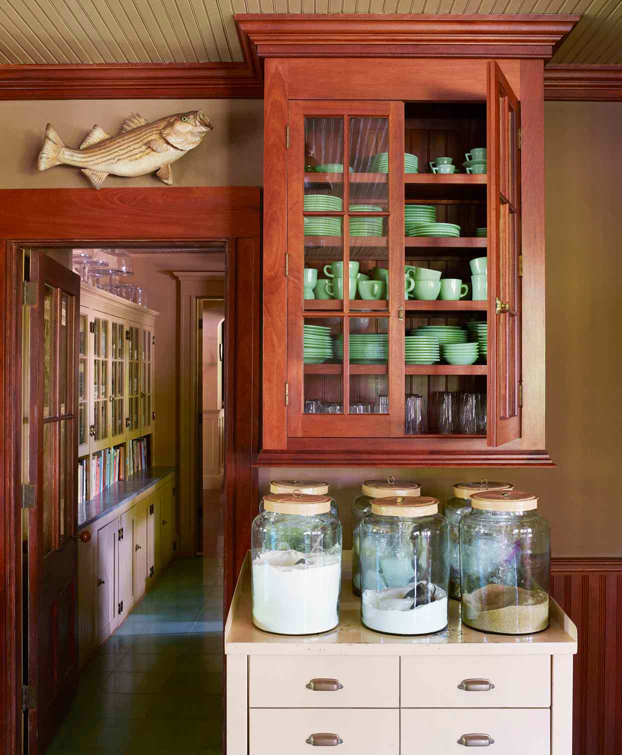 jadeite dishes fill a hanging mahogany cabinet