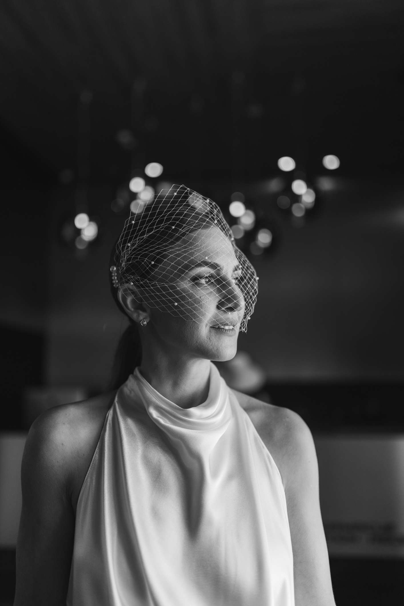 Black and white portrait of bride with birdcage veil 