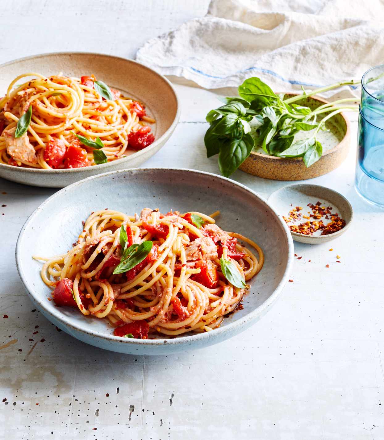 spaghetti and no-cook tomato-tuna sauce topped with basil leaves
