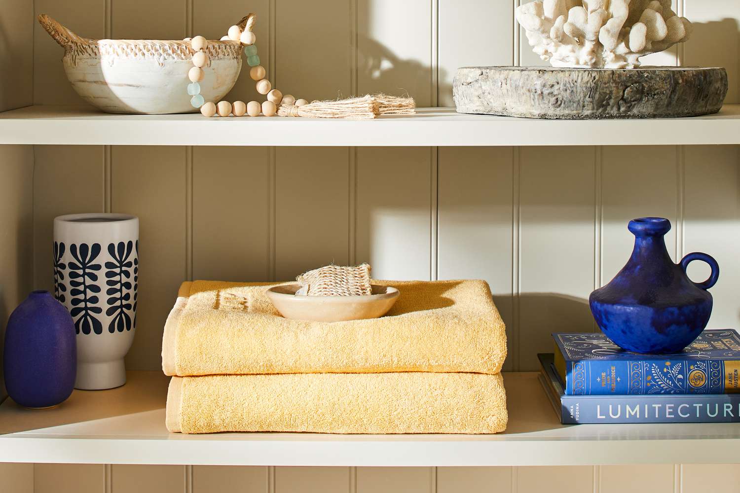 The Hay Mono Cotton Bath Towel folded on a shelf.