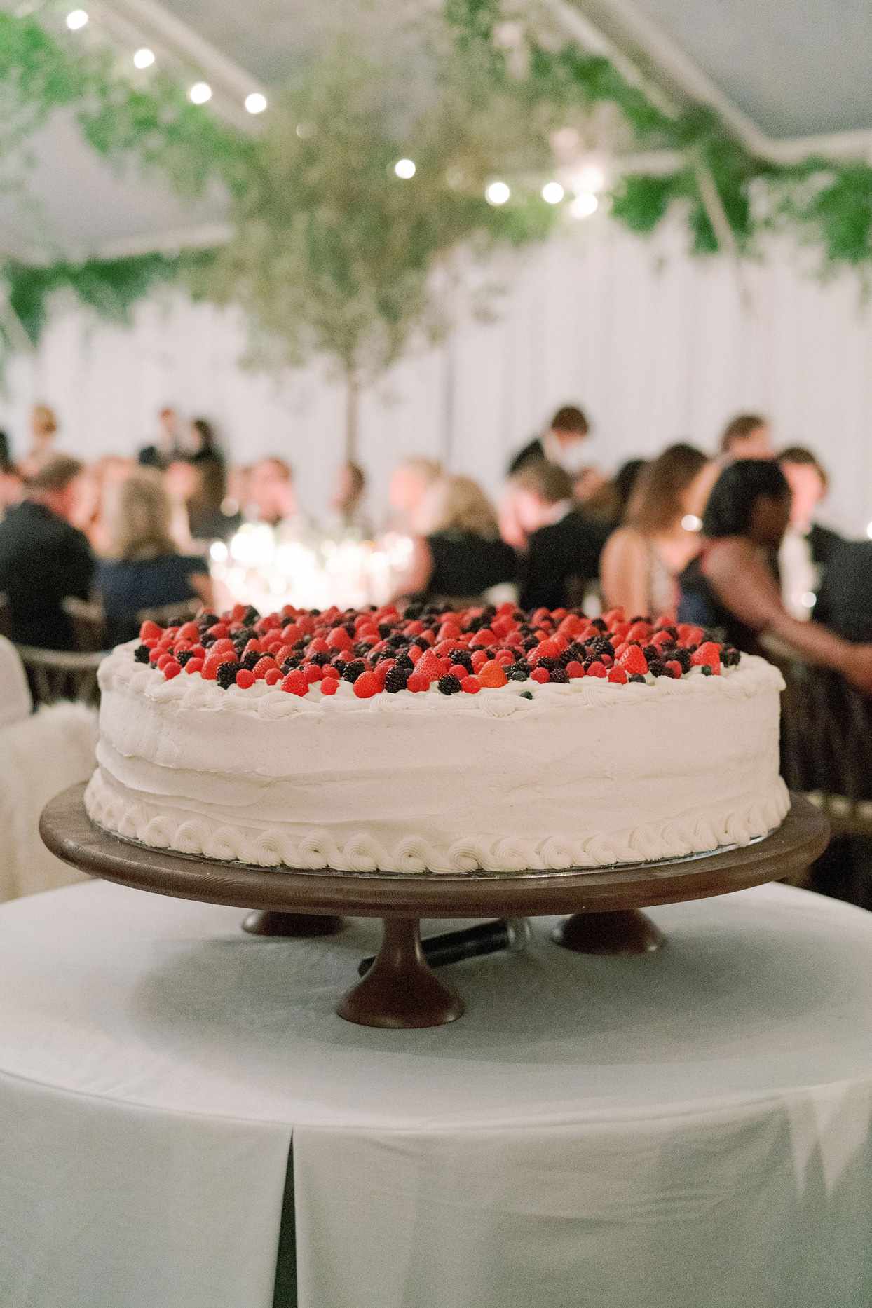 one tier white wedding cake topped with fresh berries