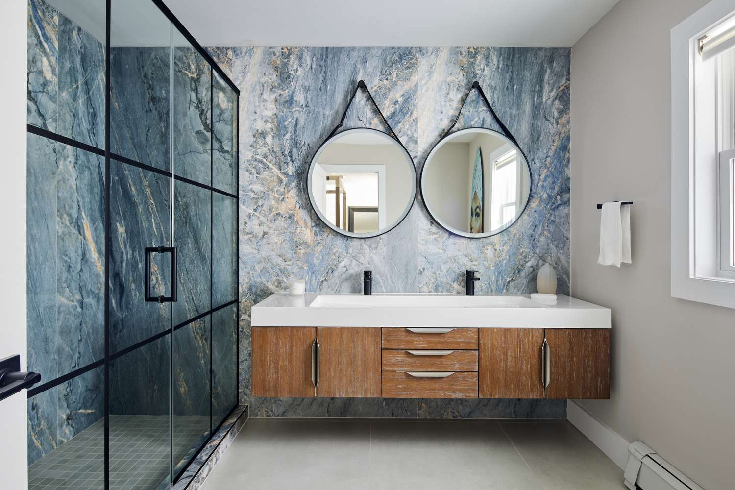 blue stone bathroom with circle mirrors 