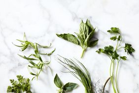 Fresh herbs including basil, dill, and mint