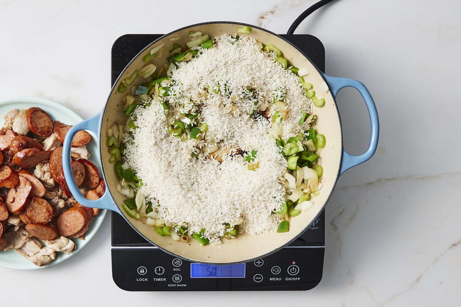 Vegetables and rice in skillet with chick and sausage 